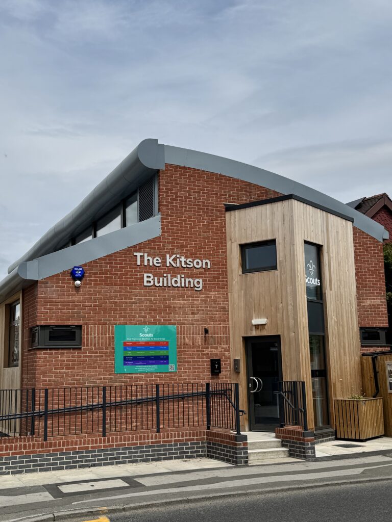 The Kitson Building. A red brick building with a curved roof. Steps and an accessibility ramp shown.